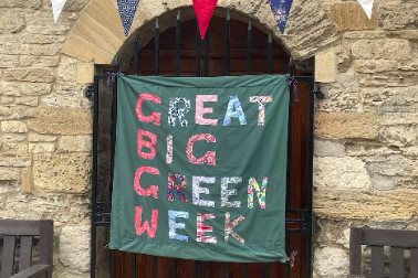 GBGW 2022 - A banner for the Great Big Green Week hanging in Eynsham's market square - Photographer Laura Stringer